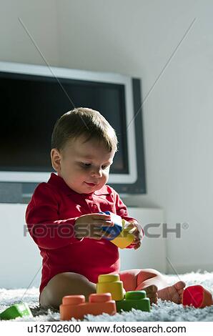 Baby boy playing with toys View Large Photo Image Stock Image - Baby boy playing with toys. Fotosearch