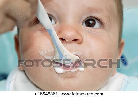 Closeup of baby boy's face with with spoon and food around his mouth View Large Photo Image Stock Image - Closeup of baby boy's face with with spoon and food around his mouth. Fotosearch