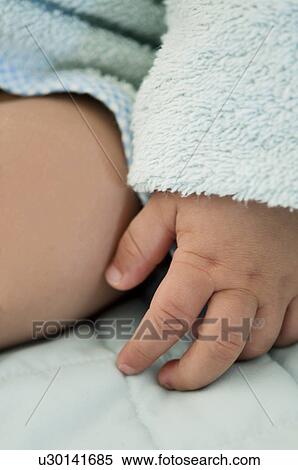Stock Photography - Closeup of baby's hand and thigh. Fotosearch