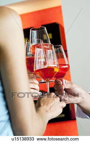 Closeup of hands holding wine glasses and toasting View Large Photo Image Stock Image - Closeup of hands holding wine glasses and toasting. Fotosearch