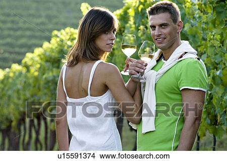 Couple in vineyard with white wine View Large Photo Image Picture - Couple in vineyard with white wine. Fotosearch
