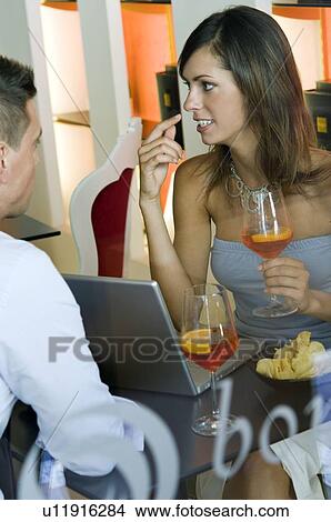 Picture - Couple sitting at laptop. Fotosearch