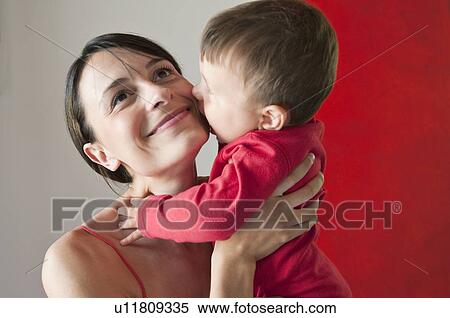 Stock Photography - Young woman holding baby boy. Fotosearch