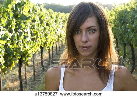 Stock Photo - Young woman in vineyard. Fotosearch