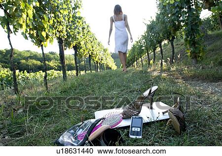Young woman in vineyard with high heel shoes, mobile, laptop, and personal care bag in foreground View Large Photo Image Stock Image - Young woman in vineyard with high heel shoes, mobile, laptop, and personal care bag in foreground. Fotosearch