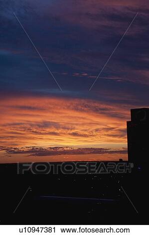 a beautiful sunset sky over a city View Large Photo Image Stock Image - a beautiful sunset sky over a city. Fotosearch