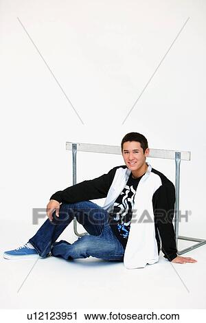 a boy sitting in front of a barrier View Large Photo Image Stock Image - a boy sitting in front of a barrier. Fotosearch