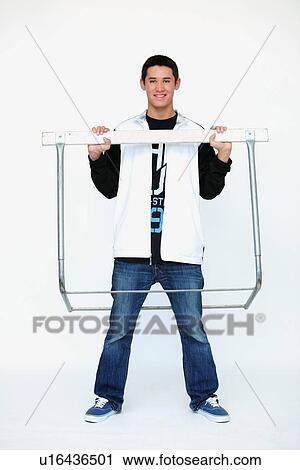 a boy standing inside the metal frame of a barrier View Large Photo Image Stock Image - a boy standing inside the metal frame of a barrier. Fotosearch