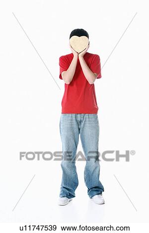a boy with a heart covering his face View Large Photo Image Stock Photo - a boy with a heart covering his face. Fotosearch