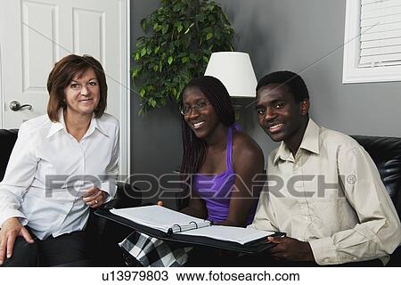 a businesswoman meeting with a couple View Large Photo Image Stock Image - a businesswoman meeting with a couple. Fotosearch