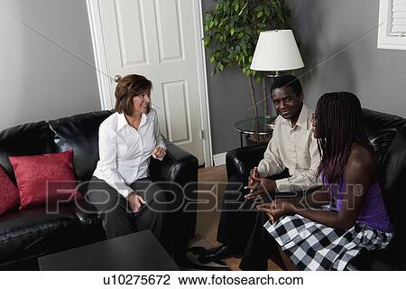 a businesswoman talking to a couple View Large Photo Image Stock Image - a businesswoman talking to a couple. Fotosearch