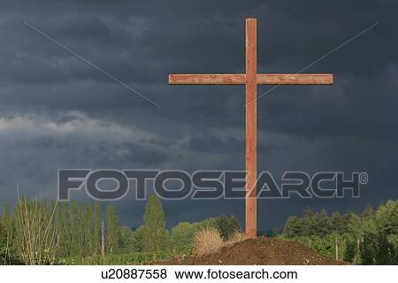 a cross on a hill with a dark sky View Large Photo Image Stock Photo - a cross on a hill with a dark sky. Fotosearch