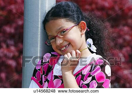 a girl holding a flower View Large Photo Image Stock Photo - a girl holding a flower. Fotosearch