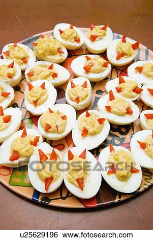a plate of deviled eggs in the shape of devil's faces View Large Photo Image Stock Photograph - a plate of deviled eggs in the shape of devil's faces. Fotosearch