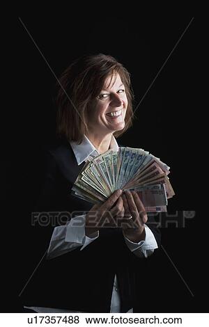 a woman fanning out dollar bills View Large Photo Image Stock Photo - a woman fanning out dollar bills. Fotosearch