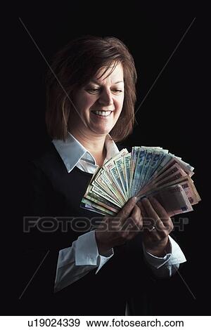 a woman fanning out dollar bills View Large Photo Image Stock Photo - a woman fanning out dollar bills. Fotosearch