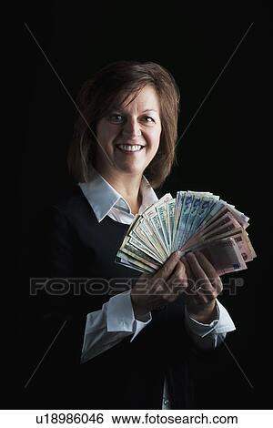 Stock Photograph - a woman fanning out dollar bills. Fotosearch