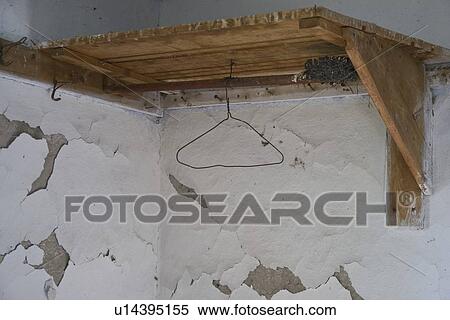 a wooden corner shelf with a hanger mounted on a wall with peeling paint View Large Photo Image Stock Photography - a wooden corner shelf with a hanger mounted on a wall with peeling paint. Fotosearch