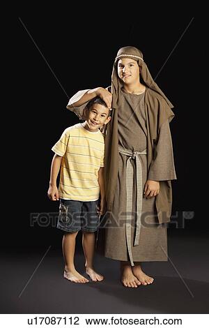 a young boy dressed up as jesus embracing another boy View Large Photo Image Stock Image - a young boy dressed up as jesus embracing another boy. Fotosearch