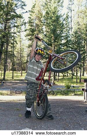 banff national park, alberta, canada; a boy plays with his bike in a campground View Large Photo Image Picture - banff national park, alberta, canada; a boy plays with his bike in a campground. Fotosearch