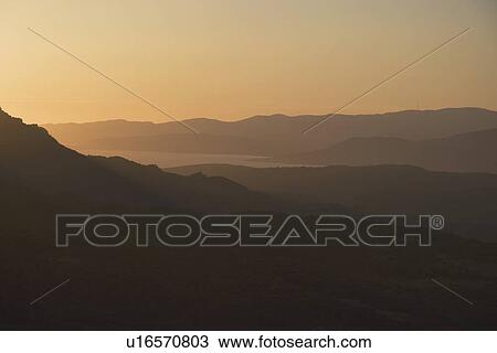Stock Image - corsica, france; silhouette of the hills at sunset. Fotosearch