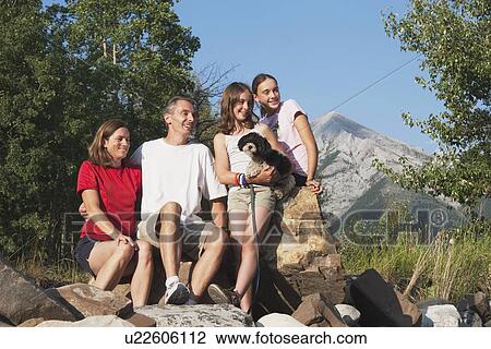 kananaskis country, alberta, canada; a family sitting on the rocks in the mountains with their dog View Large Photo Image Stock Image - kananaskis country, alberta, canada; a family sitting on the rocks in the mountains with their dog. Fotosearch