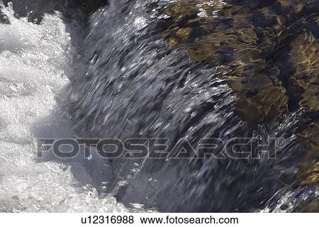 Stock Photo - kananaskis country, alberta, canada; water cascading over rocks in elbow river. Fotosearch
