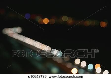 Stock Photograph - round reflections of light illuminated in the darkness. Fotosearch