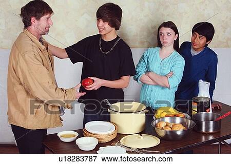 Stock Photo - teenagers serving a meal to a man. Fotosearch