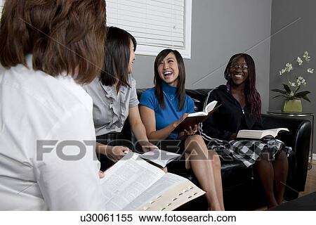 Stock Photography - women talking and laughing during a bible study. Fotosearch