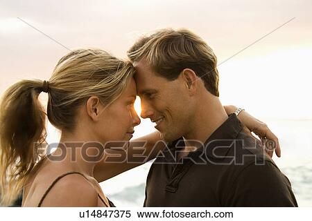 Stock Photography - Affectionate Couple By the Ocean. Fotosearch