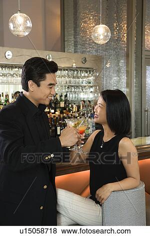 Attractive Man and Woman at Bar Having Cocktails View Large Photo Image Stock Photo - Attractive Man and Woman at Bar Having Cocktails. Fotosearch