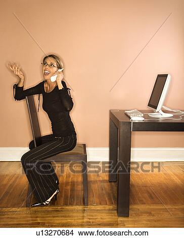 Picture - Attractive Young Businesswoman Talking on Phone. Fotosearch