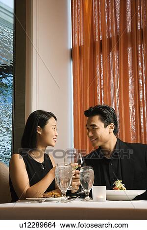 Picture - Attractive Young Couple Smiling at Each Other. Fotosearch