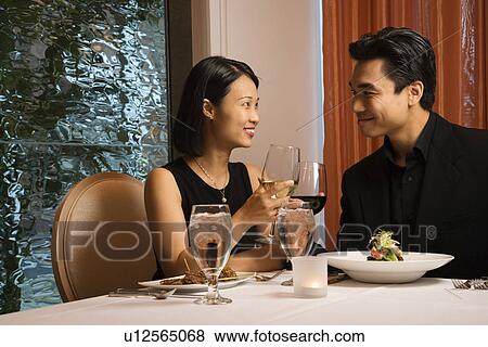 Stock Photo - Attractive Young Couple Smiling at Each Other. Fotosearch