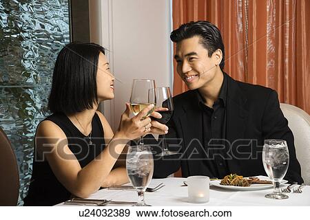 Stock Photo - Attractive Young Couple Smiling at Each Other. Fotosearch