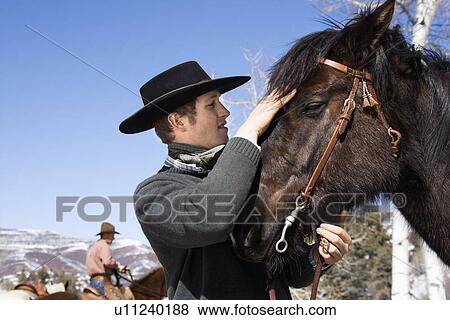 Attractive Young Man Petting Horse View Large Photo Image Stock Photo - Attractive Young Man Petting Horse. Fotosearch