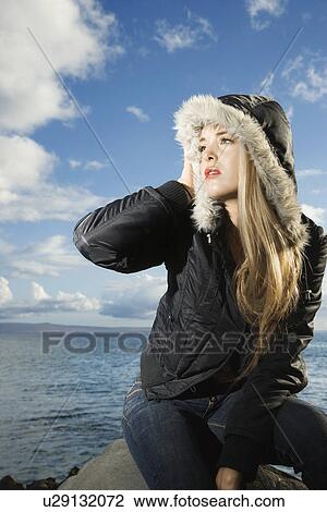 Stock Image - Attractive Young Woman by Ocean. Fotosearch