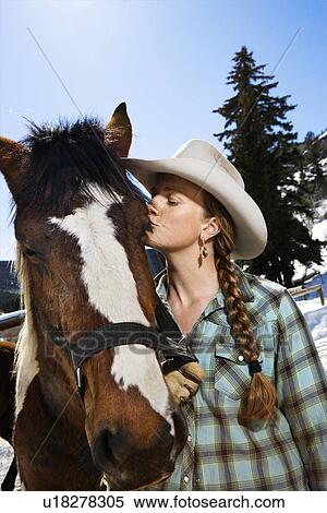 Stock Photography - Attractive Young Woman Kissing Horse. Fotosearch