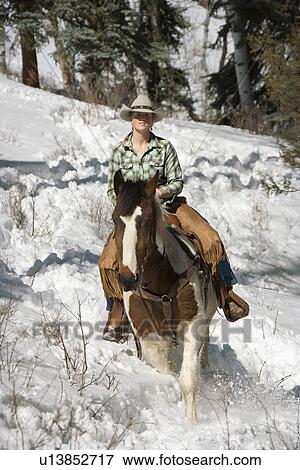 Attractive Young Woman Riding a Horse in the Snow View Large Photo Image Stock Photo - Attractive Young Woman Riding a Horse in the Snow. Fotosearch
