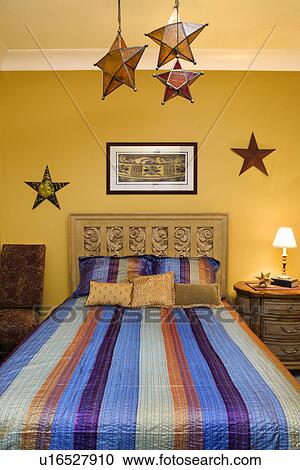 Stock Image - Bedroom Interior With Striped Bedspread and Decorative Stars. Fotosearch