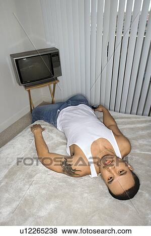 Bored Young Man Lying on Bed View Large Photo Image Stock Photo - Bored Young Man Lying on Bed. Fotosearch