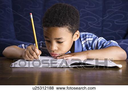 Stock Photo - Boy Doing Homework. Fotosearch