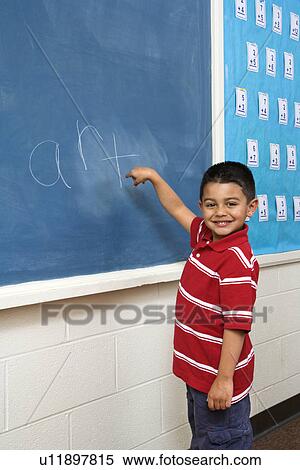 Boy in front of Blackboard View Large Photo Image Stock Photography - Boy in front of Blackboard. Fotosearch