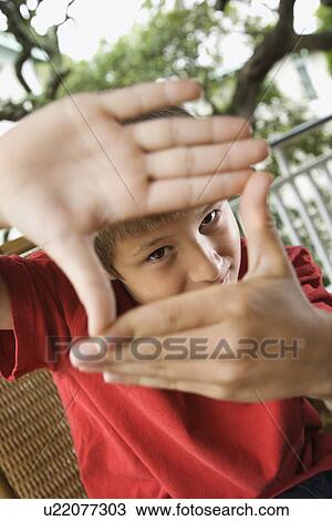 Stock Image - Boy Looking Through Hands. Fotosearch