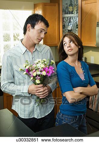 Stock Image - Boyfriend begging forgiveness. Fotosearch
