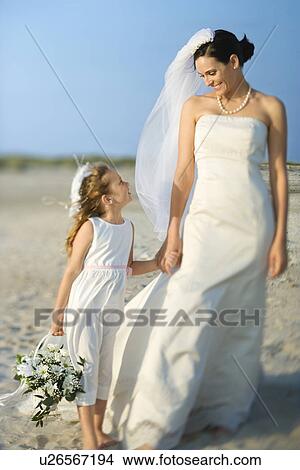 Picture - Bride and Flower Girl on Beach. Fotosearch