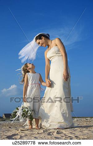 Stock Photo - Bride and Flower Girl on Beach. Fotosearch