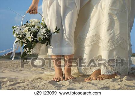 Stock Photo - Bride and Flower Girl on Beach. Fotosearch