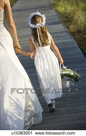 Stock Image - Bride and Flower Girl on Boardwalk. Fotosearch